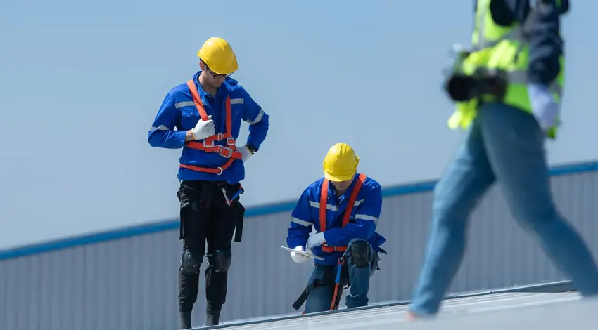 Roofing crew inspecting commercial metal roof – Dallas Roofings