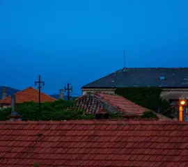 Tile rooftops at dusk in residential area – Dallas Roofings