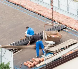 Roofers installing tiles on residential roof – Dallas Roofings