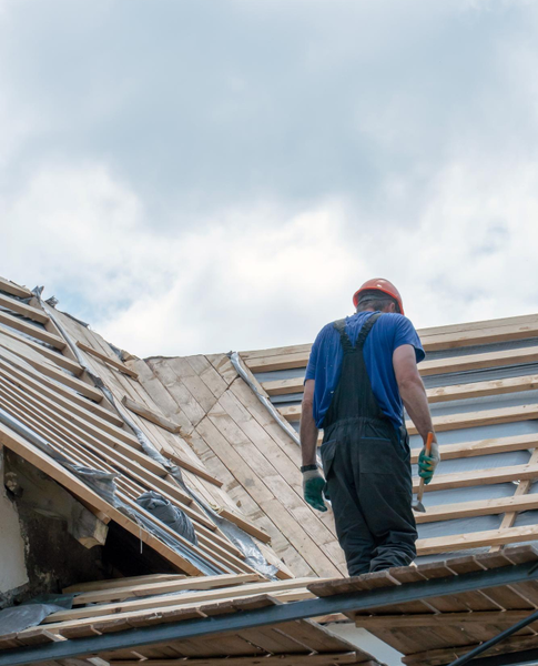 Roofer assessing damaged roof structure – Dallas Roofings