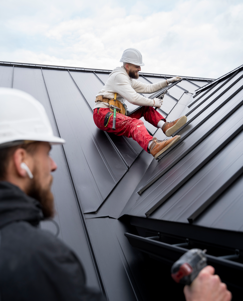 Roofers installing metal roofing panels – Dallas Roofings